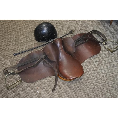 760 - A Jockey Skull cap/helmet 54/55cm and a pony saddle.