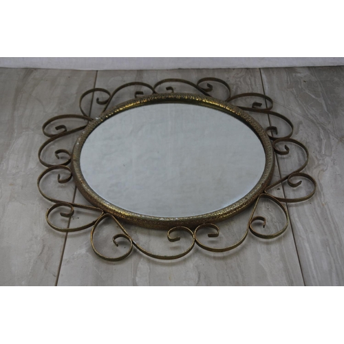 765 - A vintage wall mirror.  Approx 40cm dia.