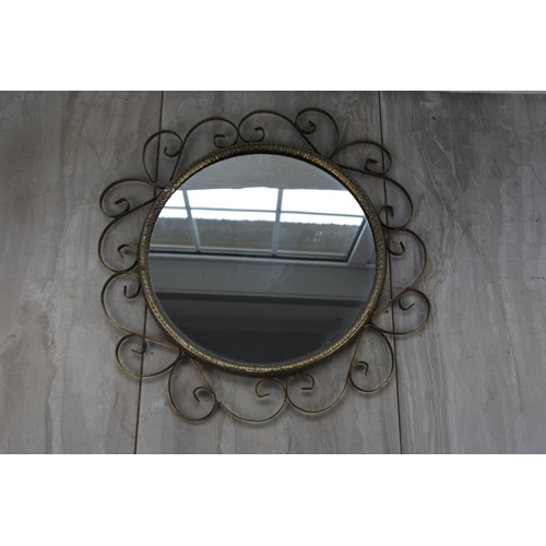 765 - A vintage wall mirror.  Approx 40cm dia.