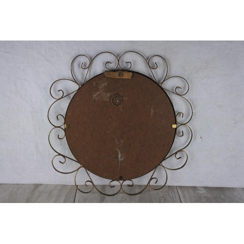 765 - A vintage wall mirror.  Approx 40cm dia.