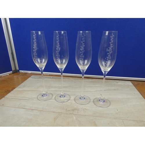 72 - Four Dartington champagne flutes decorated with heart design.