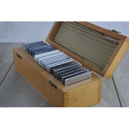 127 - A wooden cased set of various slides
