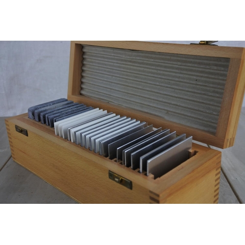 134 - A wooden cased set of various slides.