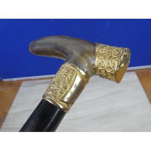 216 - A stunning antique ebony walking cane with horn handle and mounted collar and engraved plaque 'Prese... 