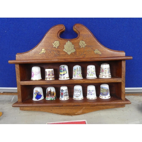 286 - A wood and brass presentation case for thimbles, a collection of souvenir thimbles and spoons.