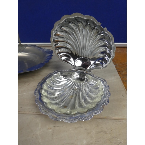 314 - A vintage silver plated swing handle serving dish and two shell shaped silver plate and glass butter... 