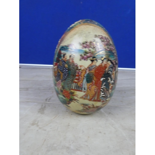 404 - An oriental patterned ceramic egg ornament.