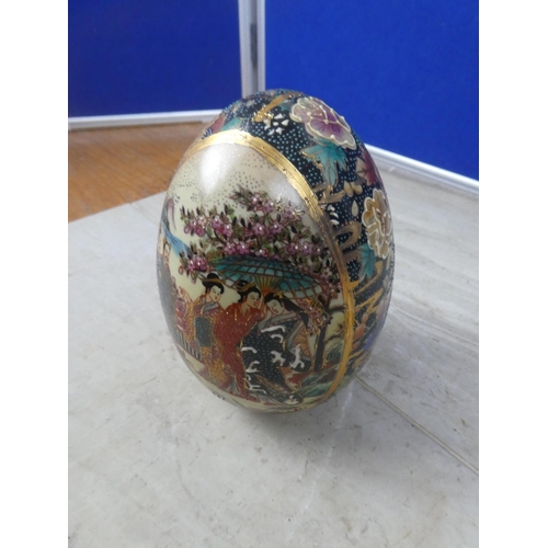404 - An oriental patterned ceramic egg ornament.