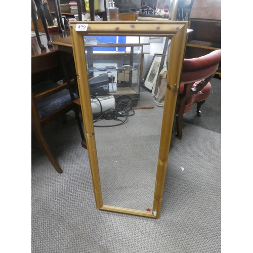 499 - A pine framed mirror.  Approx 38x98cm.