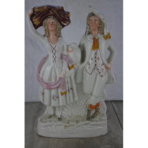 677 - An antique Staffordshire figure (a/f).  Approx 32cm.