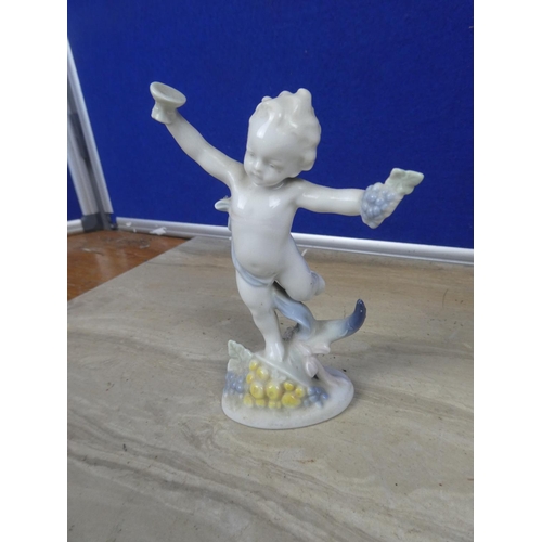 721 - A porcelain figure of a cherub or putti, European manufacturer, marks to the base and A Victorian Bo... 