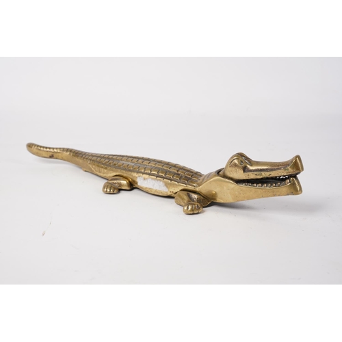 16 - A large heavy brass 'Crocodile' nut cracker, measuring 34cm.