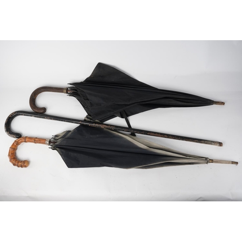 3 - Two vintage umbrellas and a wooden walking cane.