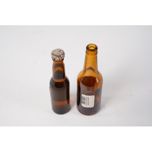 59 - Two miniature glass bottles of Guinness and Budweiser, measuring 9cm.