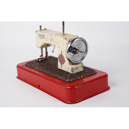 61 - A vintage Comet Crystal tin plate child's sewing machine, measuring 21cm x 12cm.