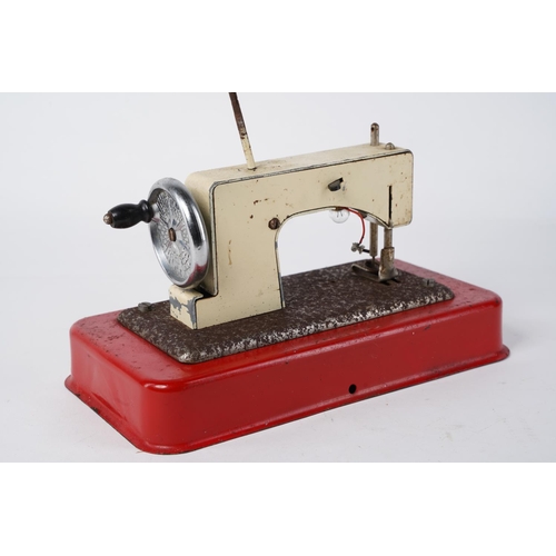 61 - A vintage Comet Crystal tin plate child's sewing machine, measuring 21cm x 12cm.