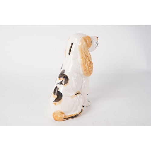 63 - A ceramic dog money box, measuring 21cm.