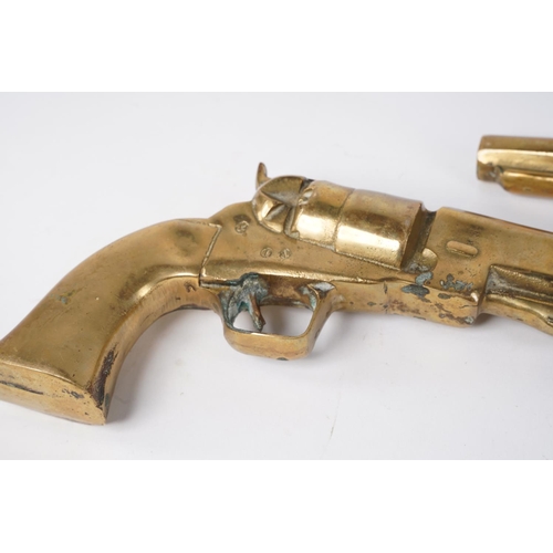 86 - A pair of large heavy brass ornamental pistols, measuring 31cm.