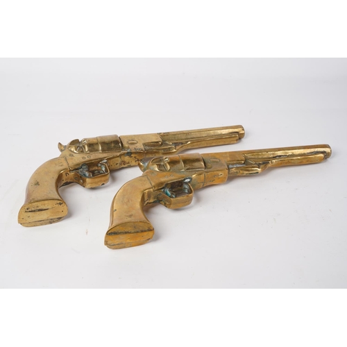 86 - A pair of large heavy brass ornamental pistols, measuring 31cm.