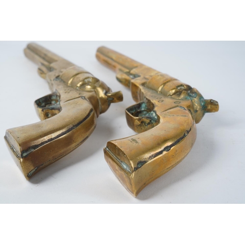 86 - A pair of large heavy brass ornamental pistols, measuring 31cm.