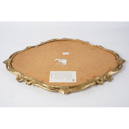 88 - A small plastic gilt framed wall mirror, measuring 38cm x 30cm.