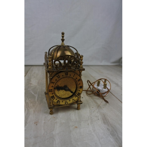 117 - An electrified antique brass mantle clock, Approx 17cm in height.