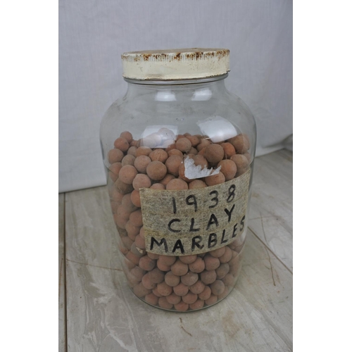 134 - A jar of clay marbles.