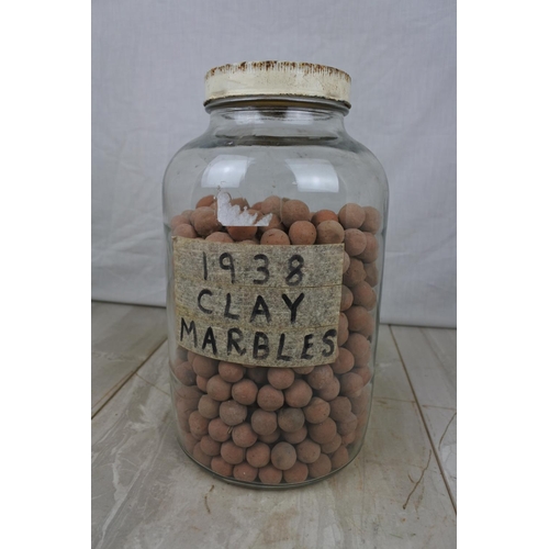 134 - A jar of clay marbles.