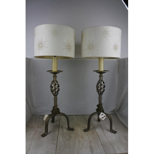 138 - A large pair of wrought iron base table lamps and shades, Approx 78cm in height.