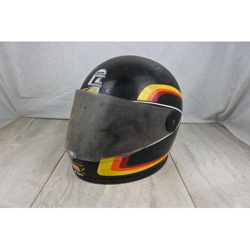 140 - A vintage motorcycle helmet.