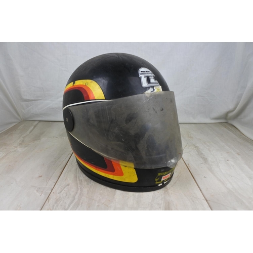 140 - A vintage motorcycle helmet.