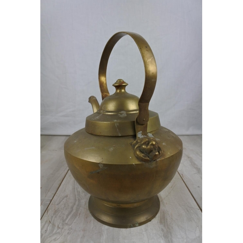 145 - A large brass kettle, Approx 22cm in height.