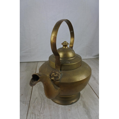 145 - A large brass kettle, Approx 22cm in height.