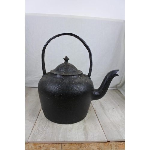 146 - A large antique black kettle with handle repaired, Approx 45cm in height.