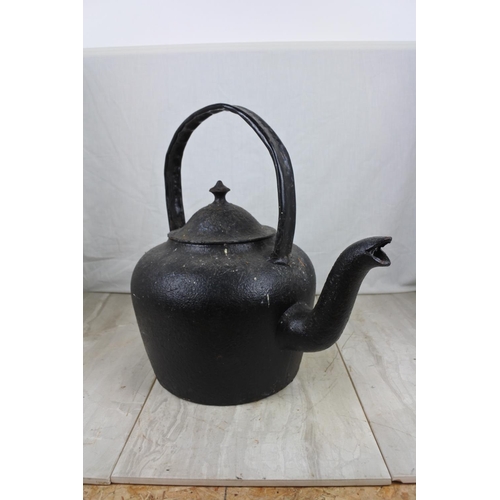 146 - A large antique black kettle with handle repaired, Approx 45cm in height.