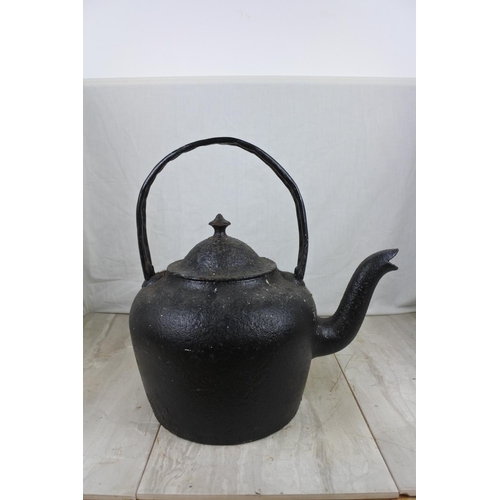 146 - A large antique black kettle with handle repaired, Approx 45cm in height.