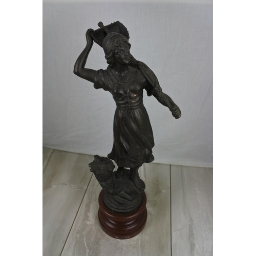 159 - A large spelter figure of a lady fishing on a wooden plinth, Approx 54cm in height.