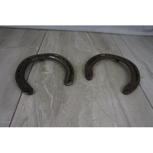 181 - Two antique horseshoes.