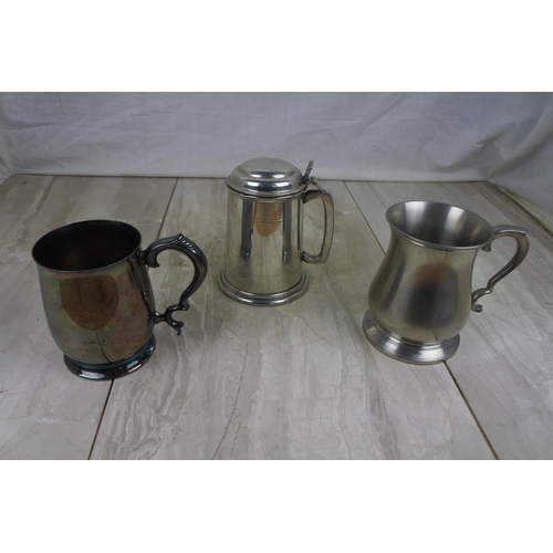 185 - An English Pewter lidded tankard and two others.