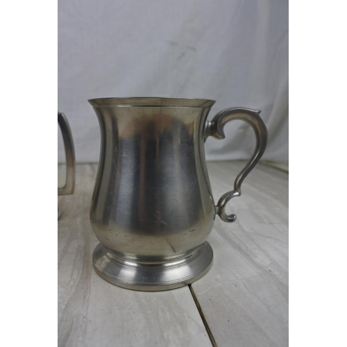 185 - An English Pewter lidded tankard and two others.