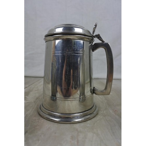 185 - An English Pewter lidded tankard and two others.