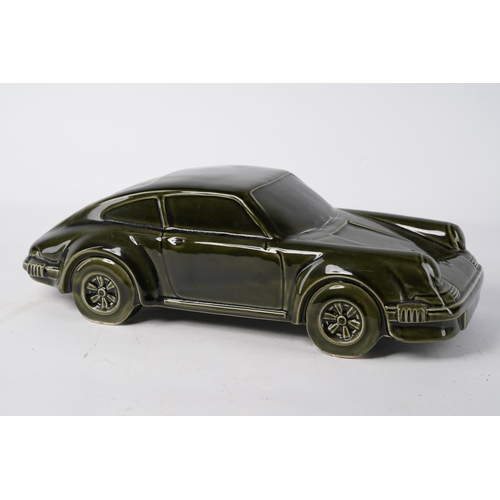 222 - A large ceramic model of a Porsche (A/F), Approx 36x15x12cm.