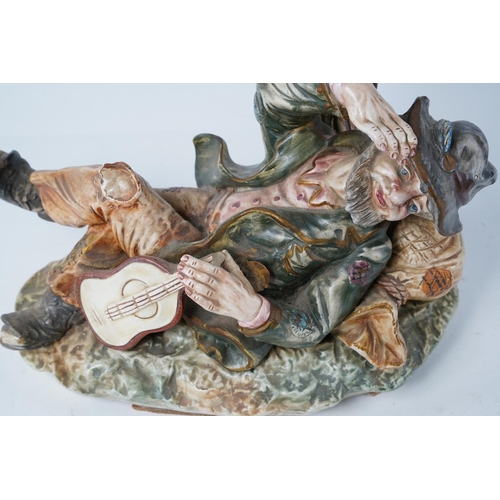 232 - A Capodimonte ceramic figure of a tramp with guitar (A/F), Approx 28cm in height.