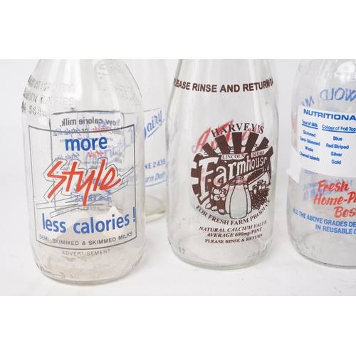 304 - A large assortment of vintage glass milk bottles.