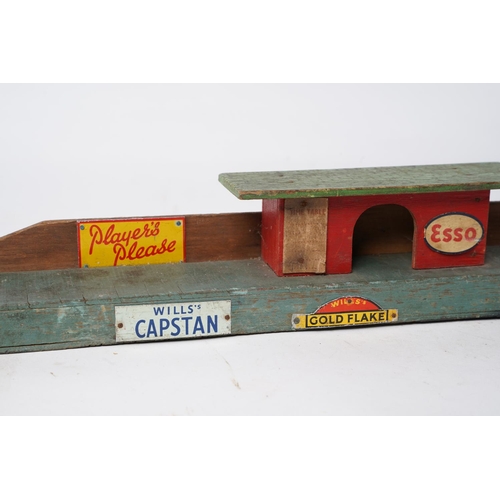 331 - A stunning vintage wooden toy platform with advertisements for Players, Esso, Will's Capstan and mor... 