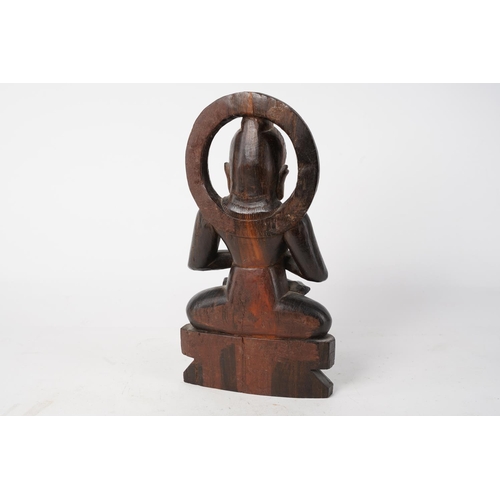 336 - A wooden Buddha figure, measuring 26cm tall.