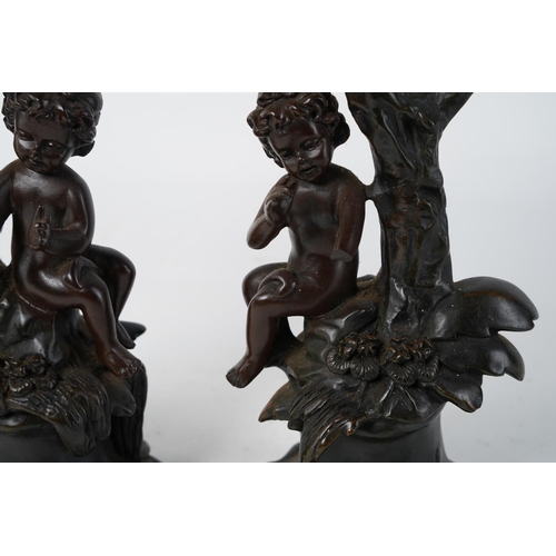 349 - A pair of figurine based candlesticks, measuring 17cm.