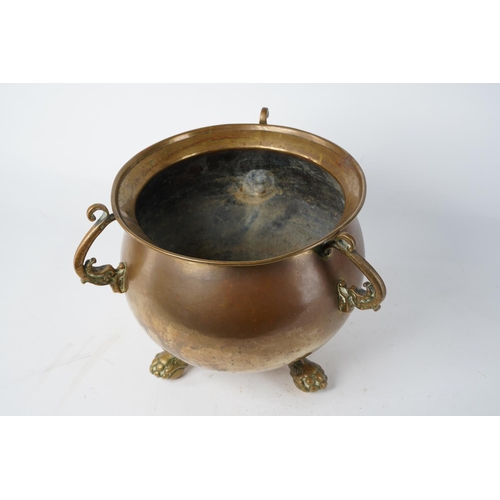 353 - A stunning antique copper and brass cauldron, sitting on ball and claw feet, measuring 22cm tall.