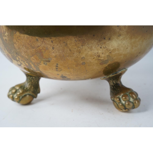 353 - A stunning antique copper and brass cauldron, sitting on ball and claw feet, measuring 22cm tall.