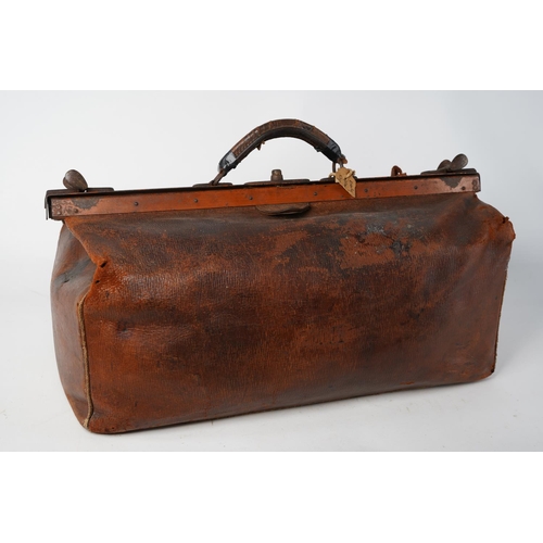 368 - An antique gladstone leather medical bag.